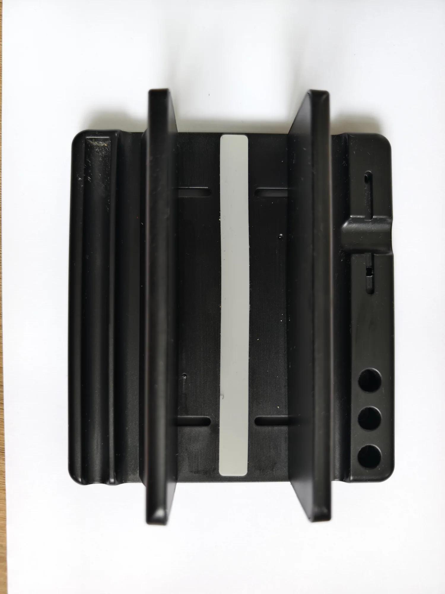 Black laptop stand on white paper