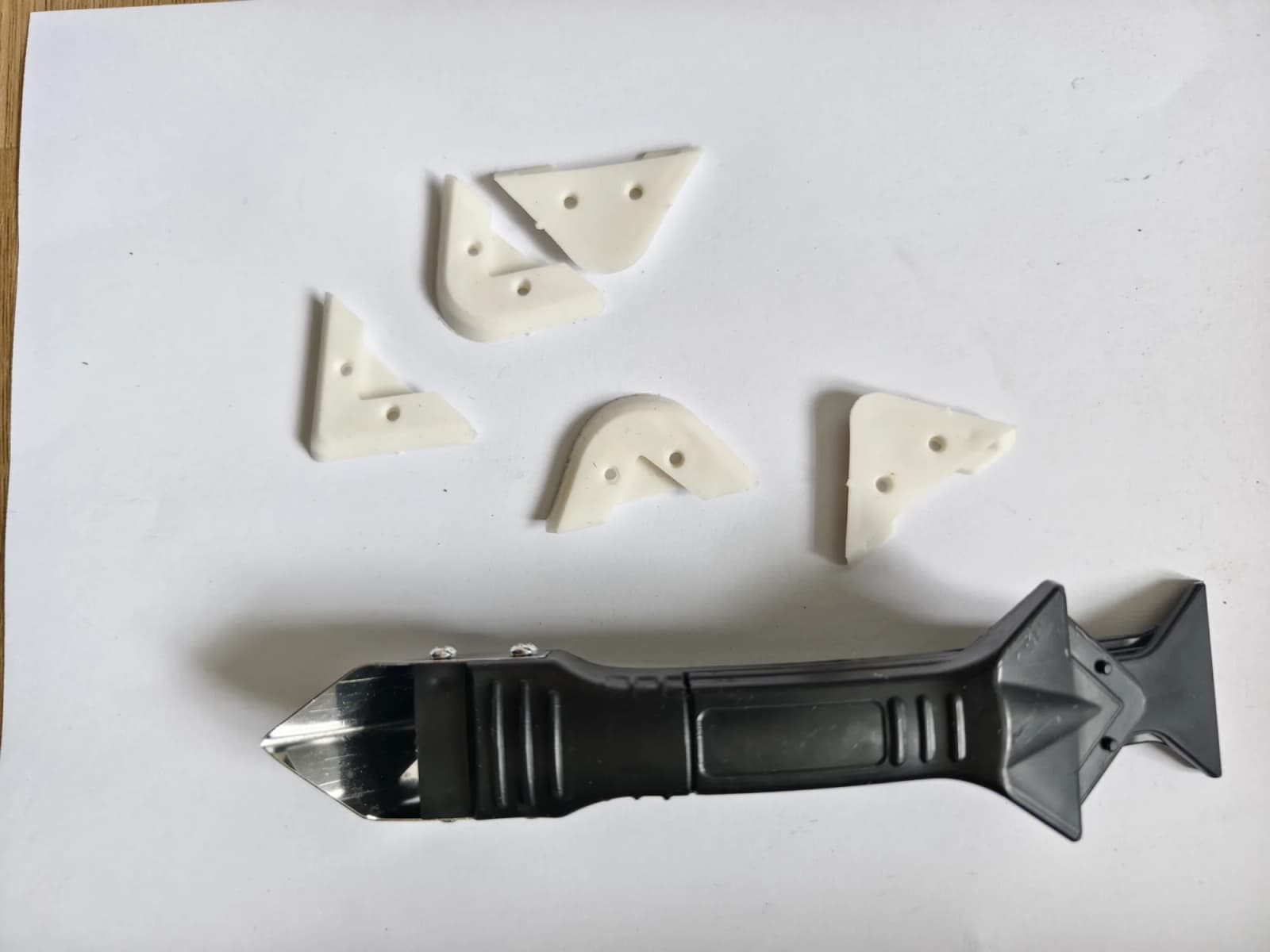 White scraper pieces on white paper